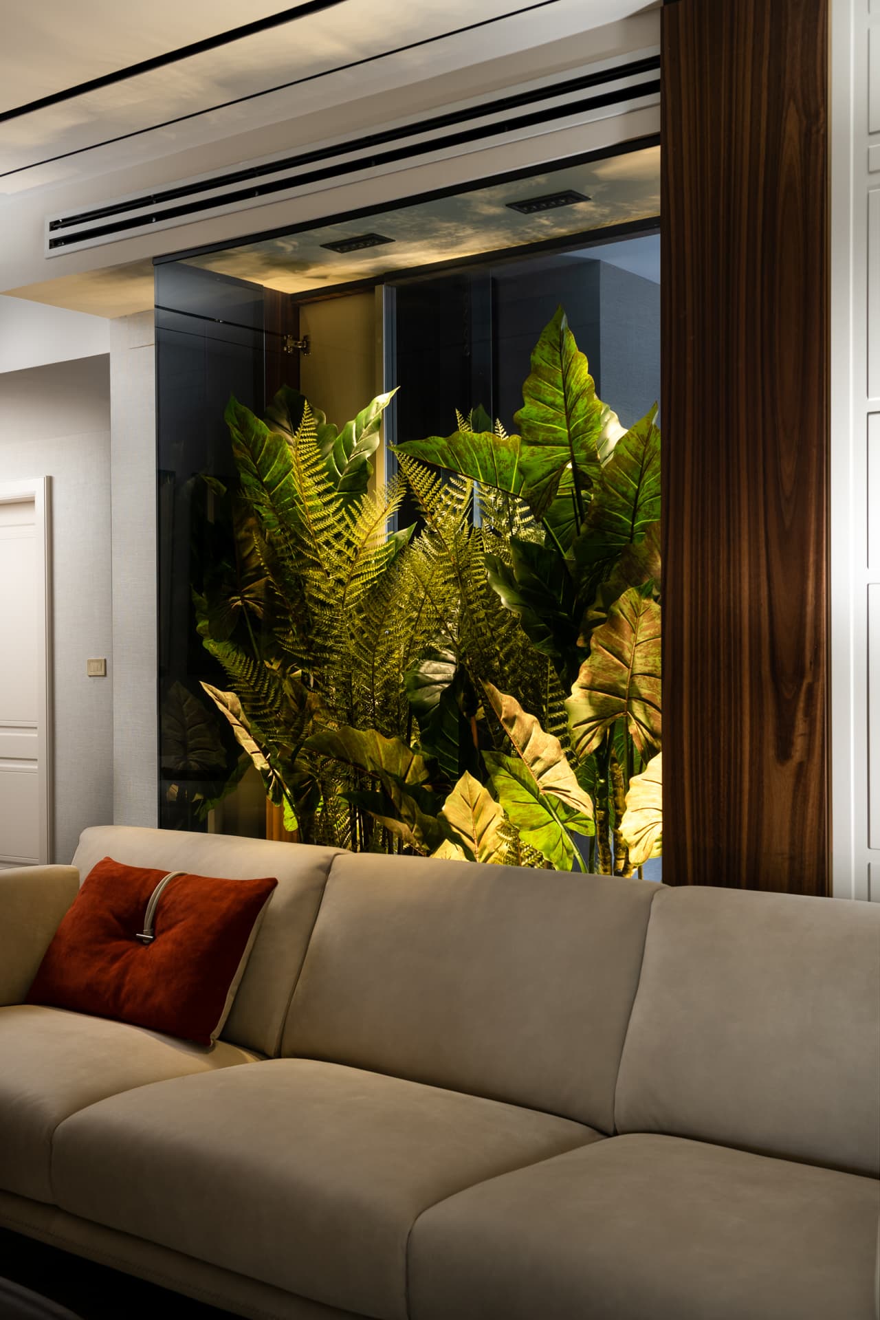 Walnut paneled column with pampas grass arrangement in alcove