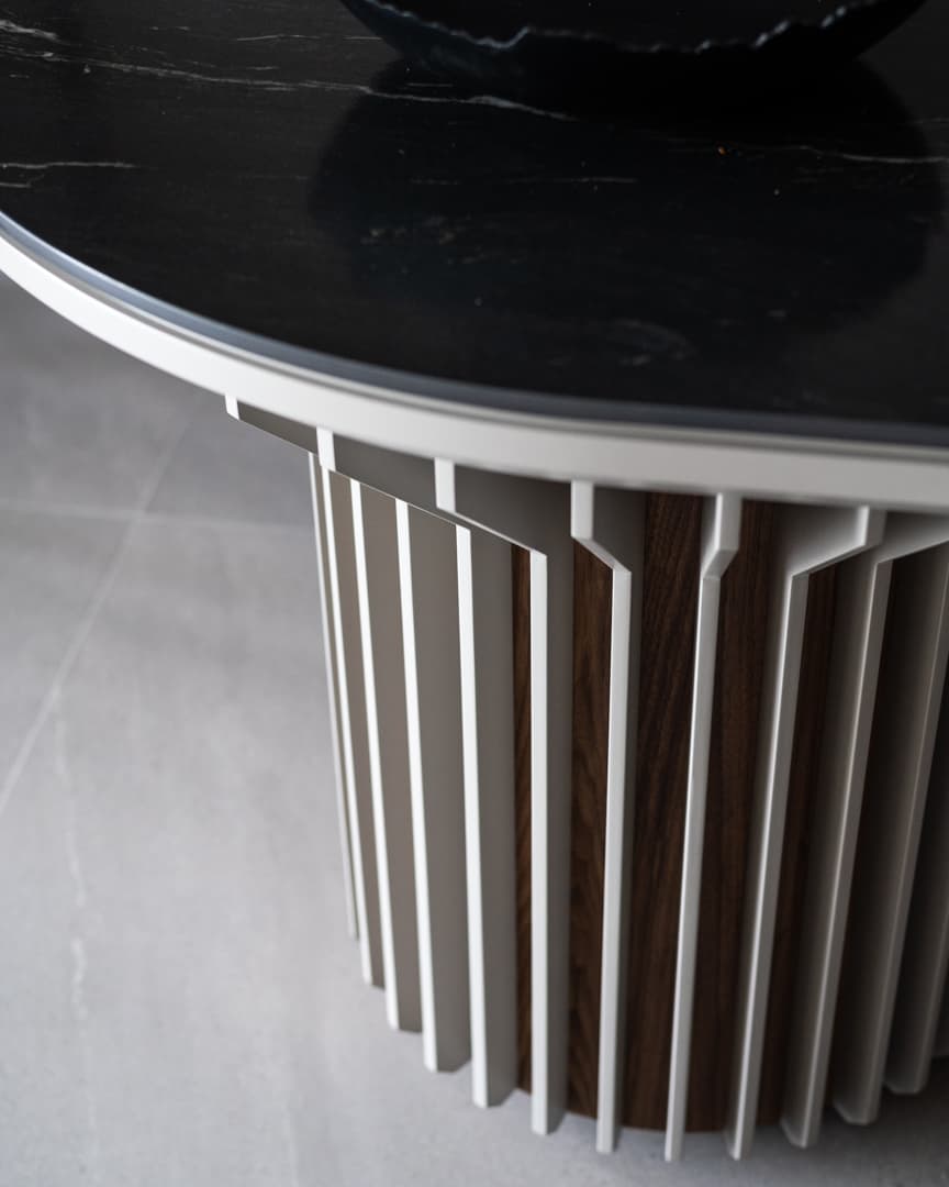 Matte black lotus bowl on walnut coffee table surface