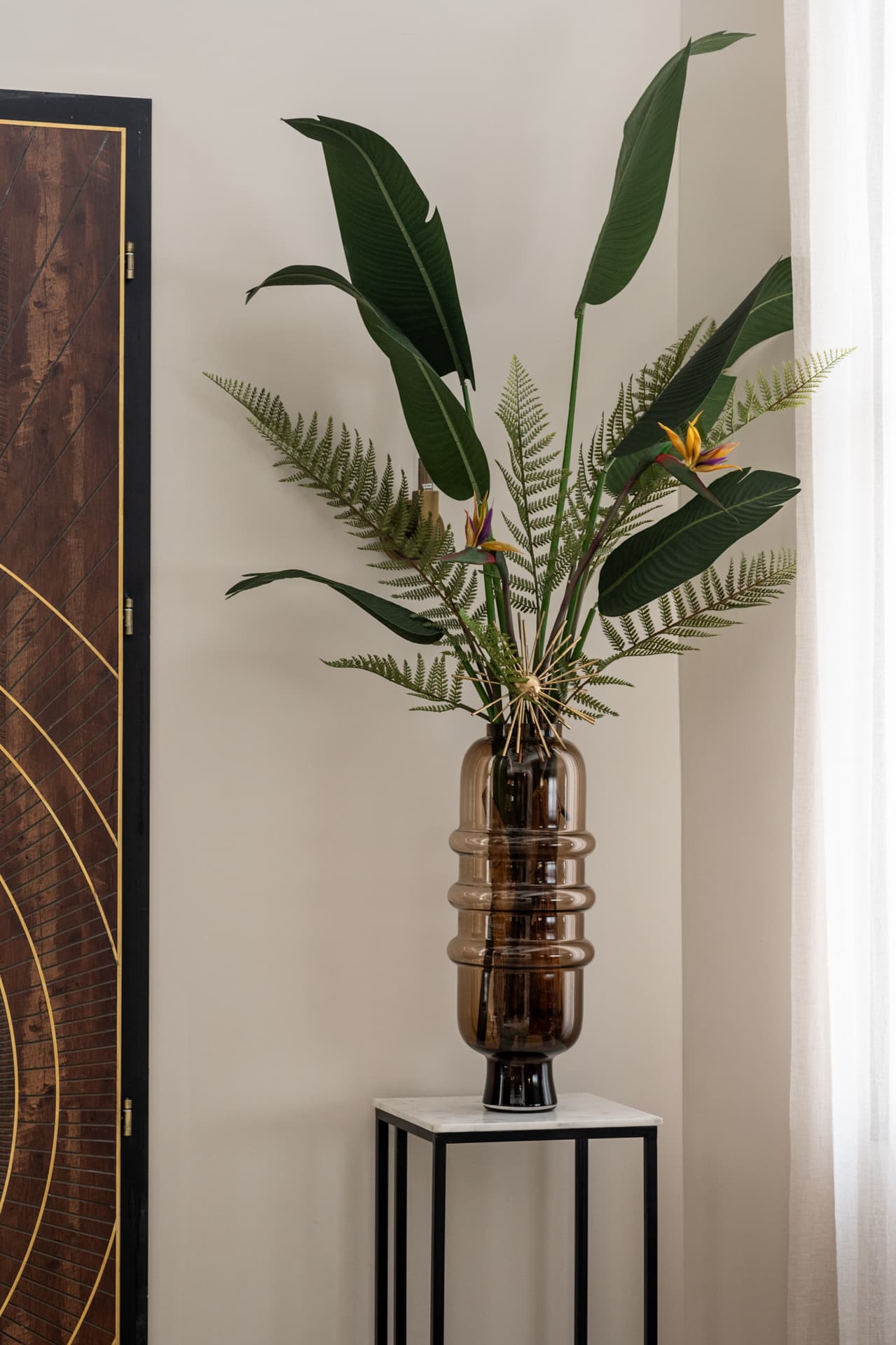 Gold geometric medallion inset on walnut-and-cream wall paneling