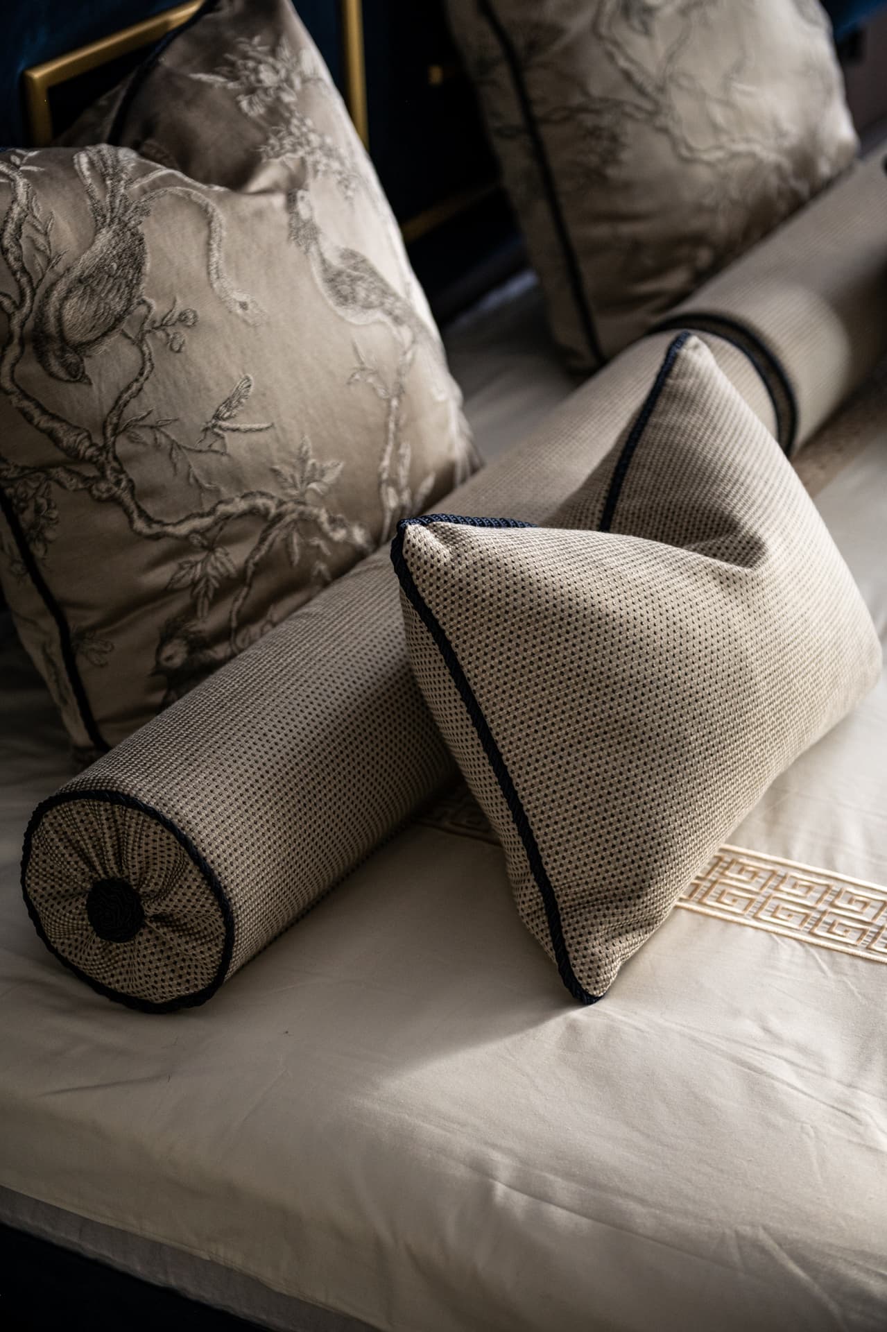 Pinch-pleated taupe diamond-stitched valance with gold downlights