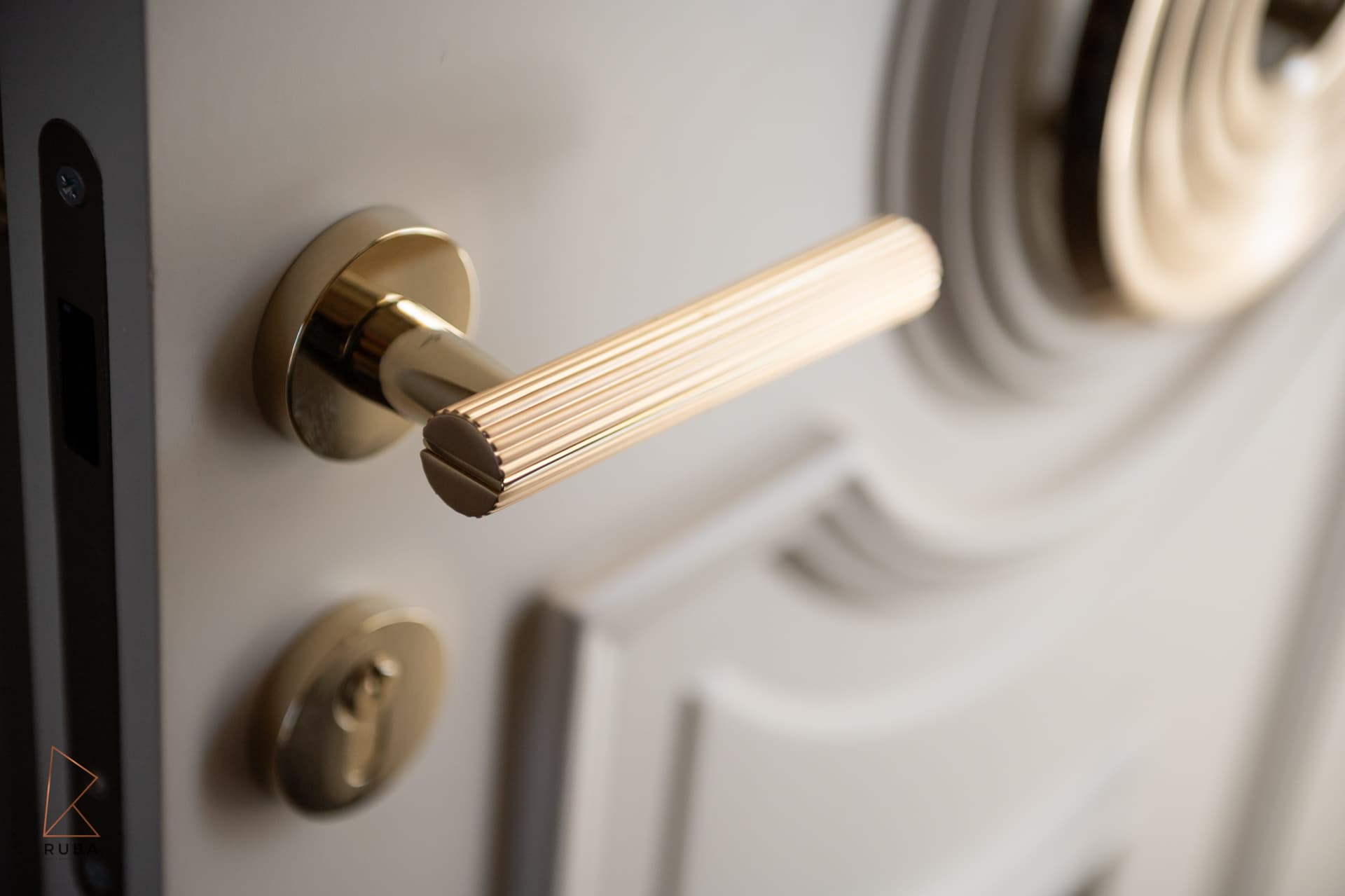 Gold fluted door handle with concentric ring door detail
