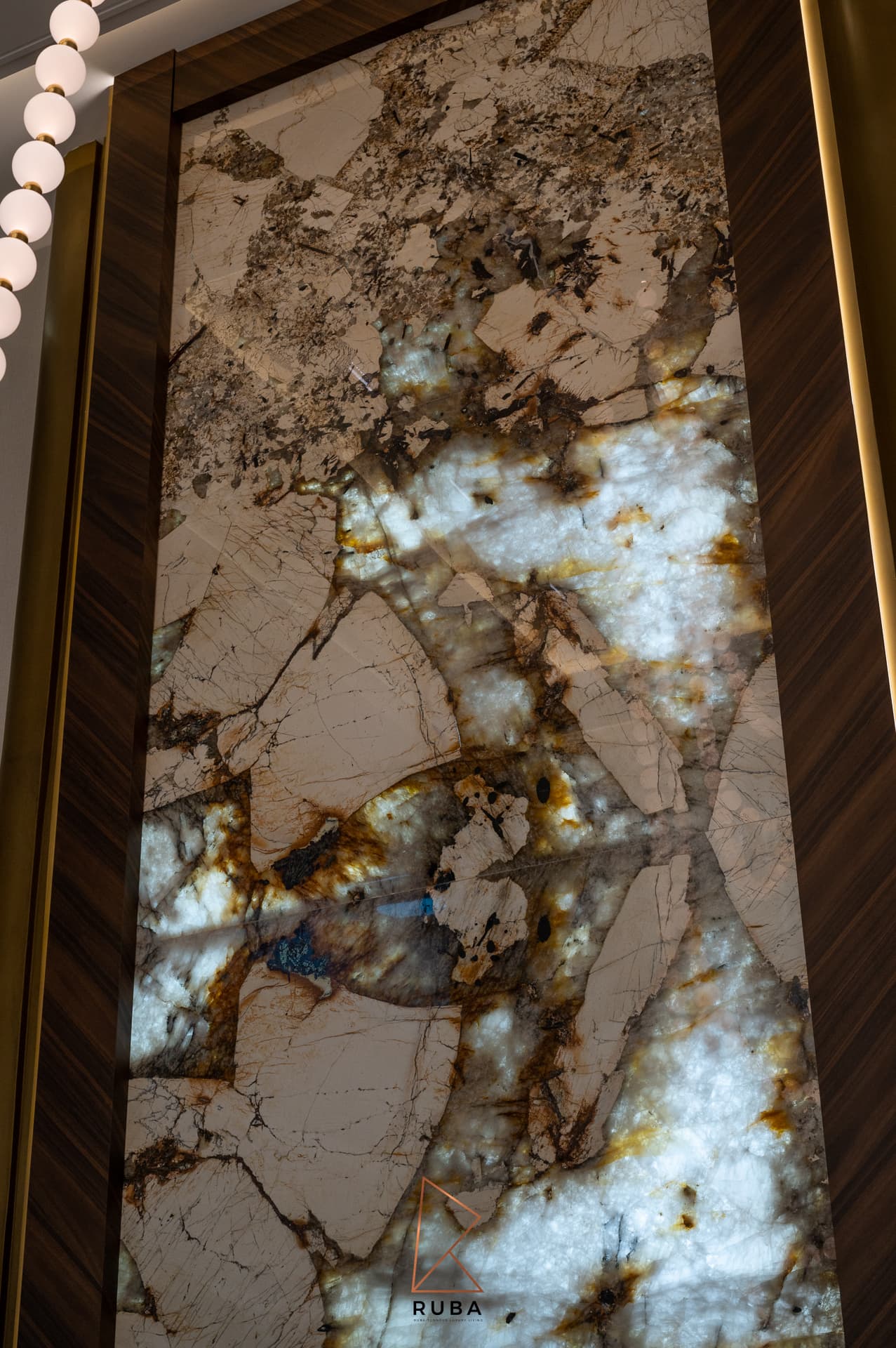 Backlit onyx island surface with amber and smoke veining