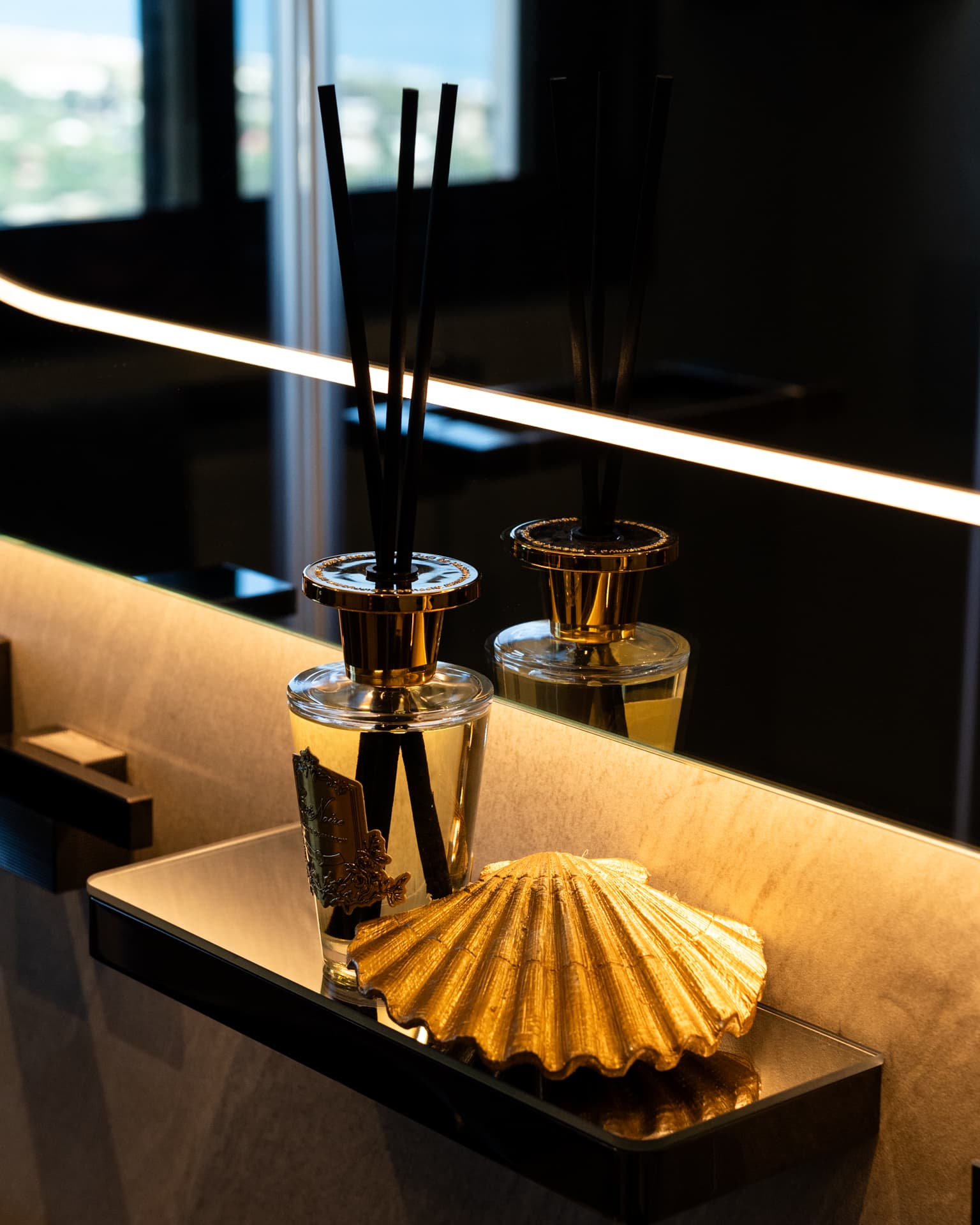 Gold shell dish with crystal diffusers on brushed brass tray
