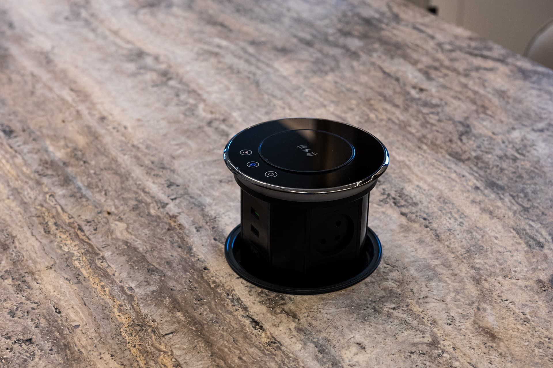 Pop-up power outlet recessed into travertine island countertop