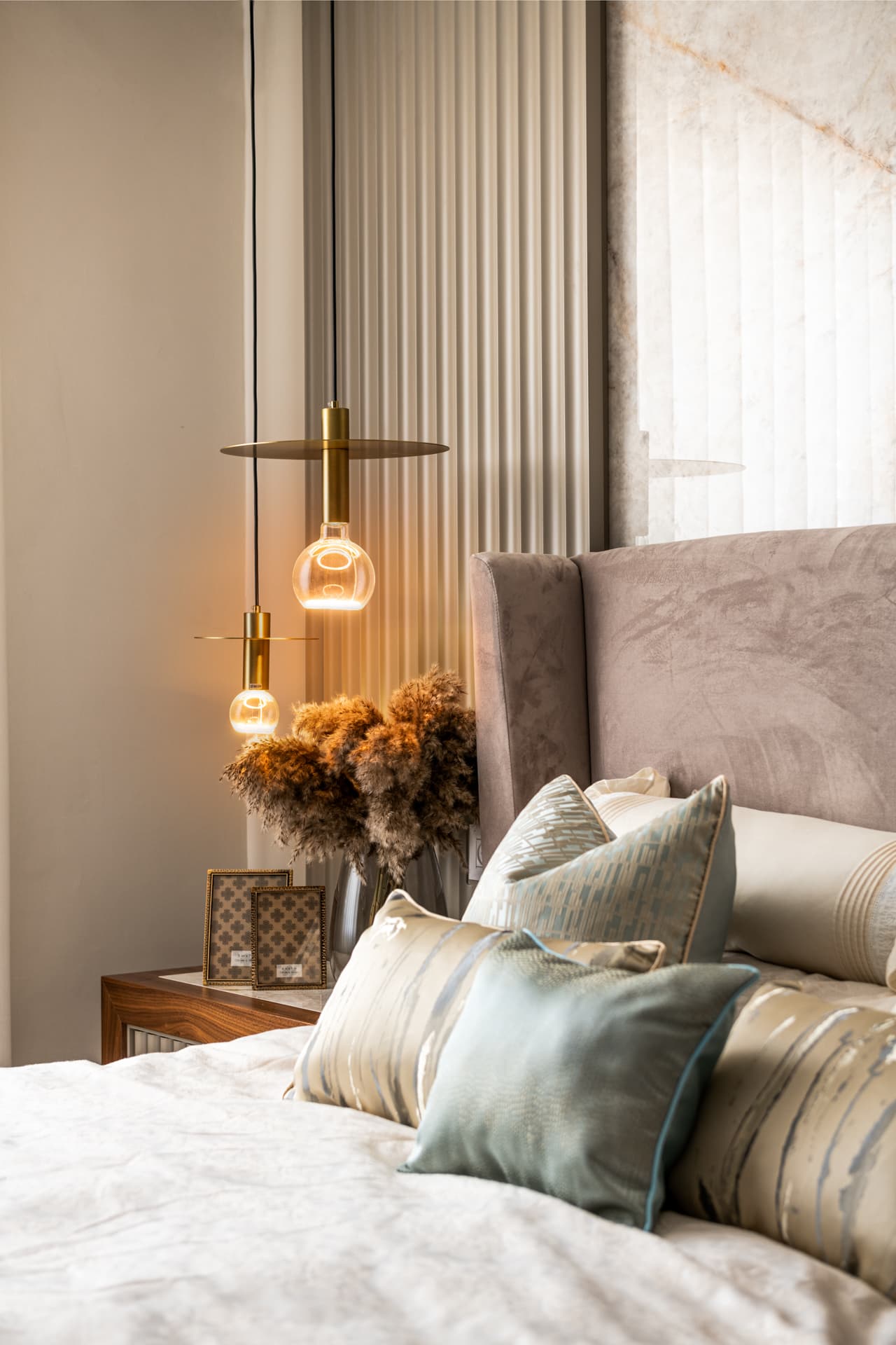 Oval LED pendant ring hovering above dark glass dining table