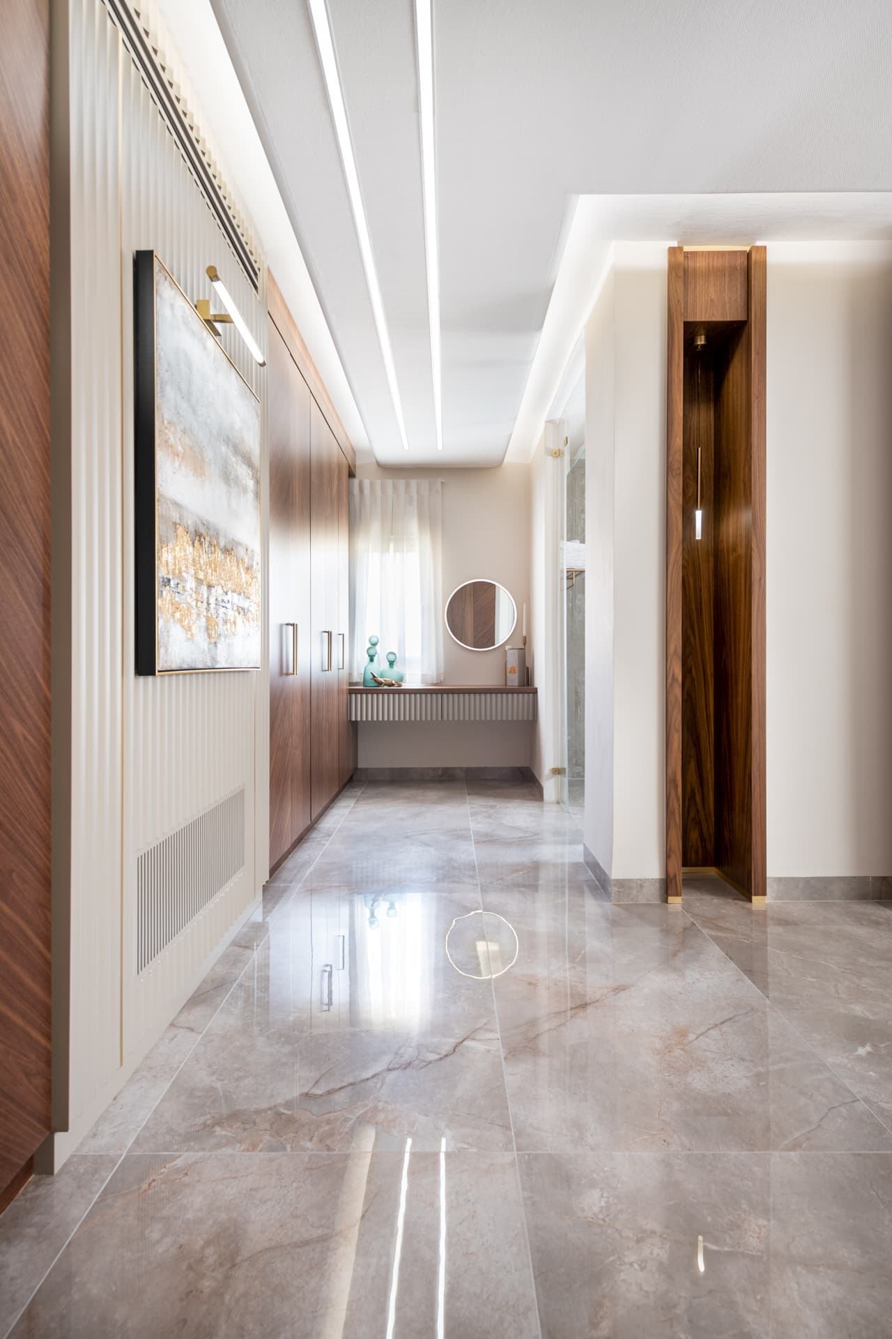Three-sided grey marble fireplace beneath walnut TV panel