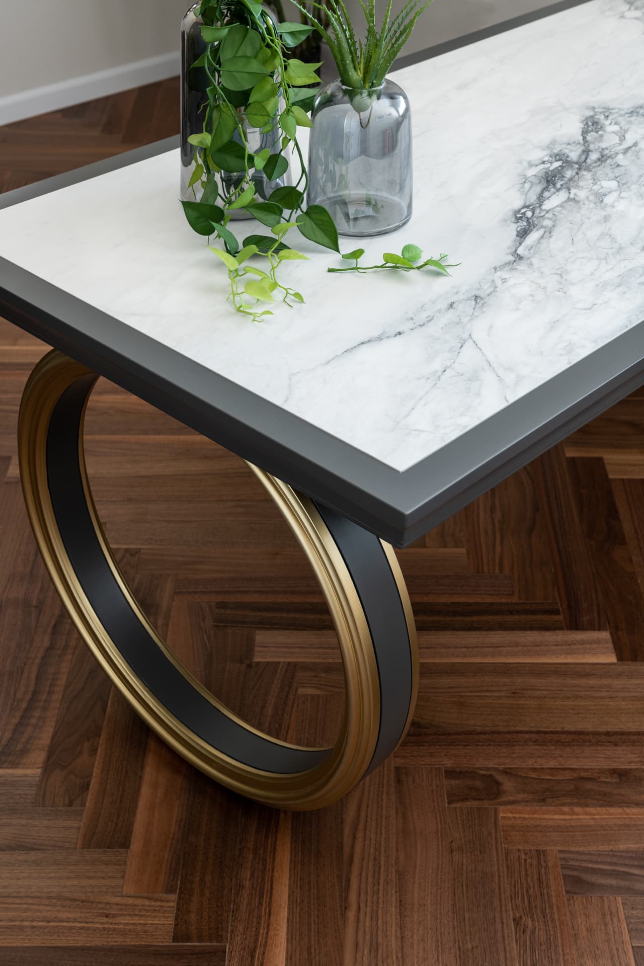 White marble reception counter with globe pendants and trailing plants