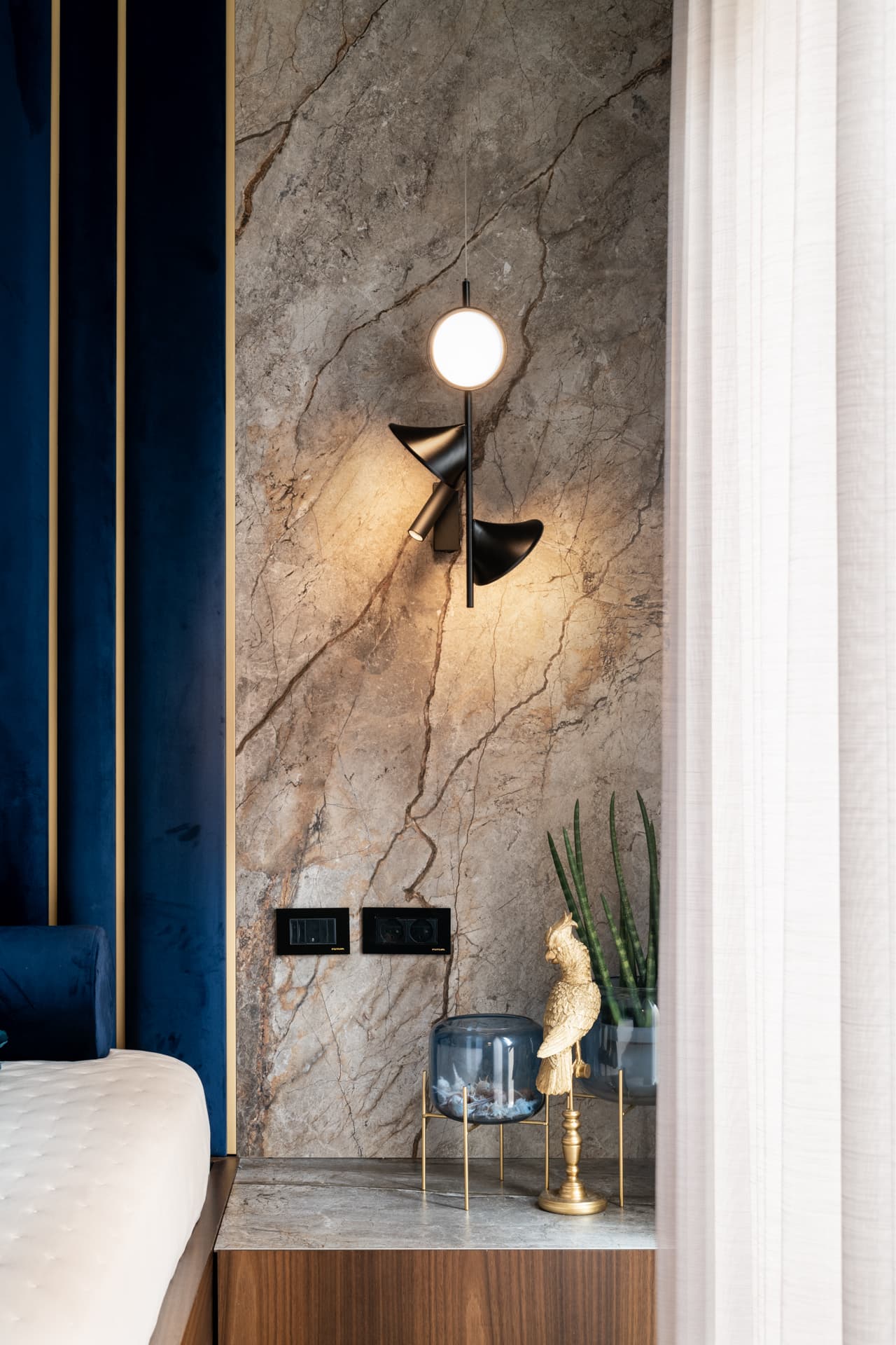 Navy velvet channel headboard with gold trim lines between channels