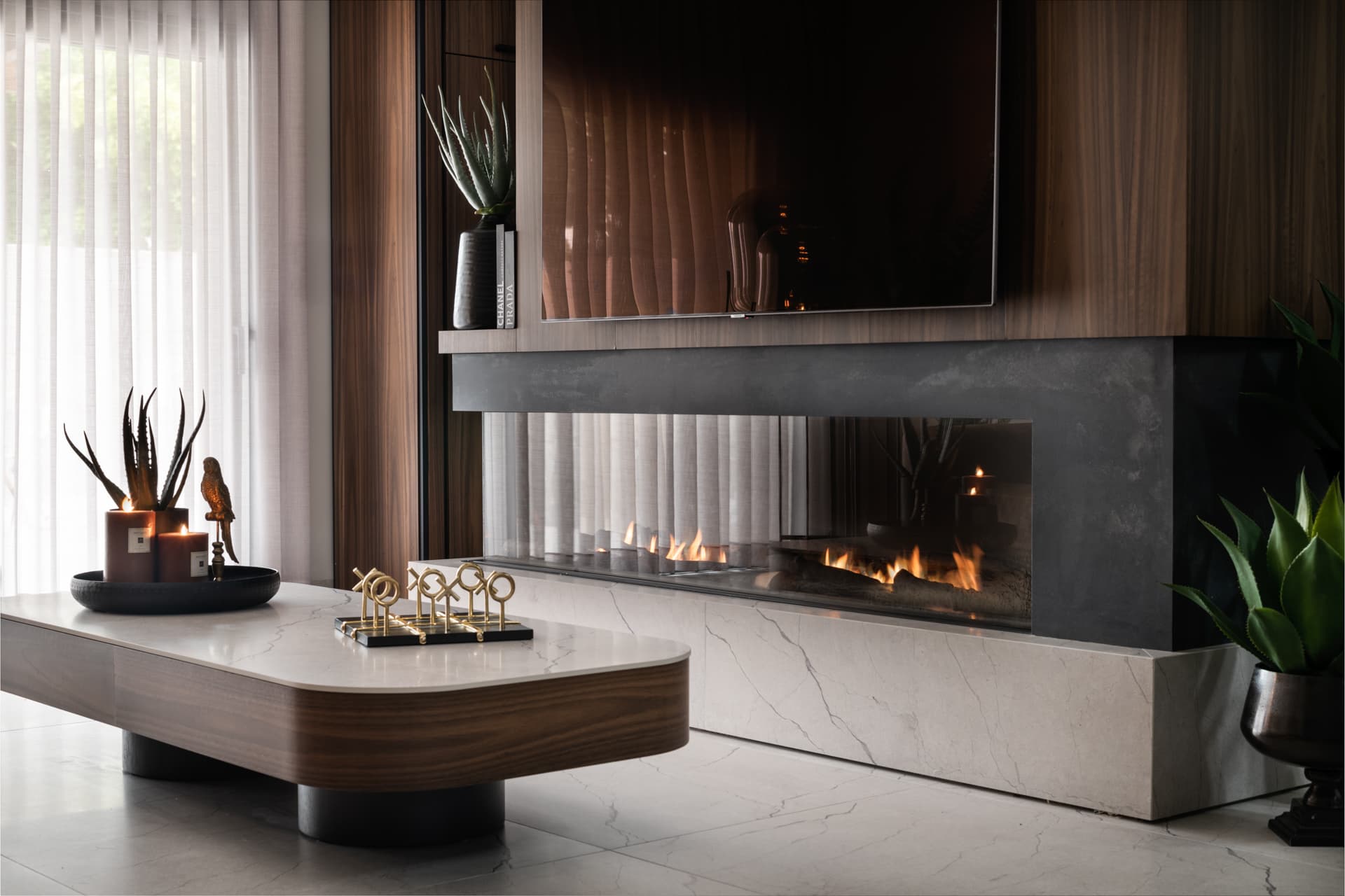 White parrot sculptures on marble-topped walnut vanity