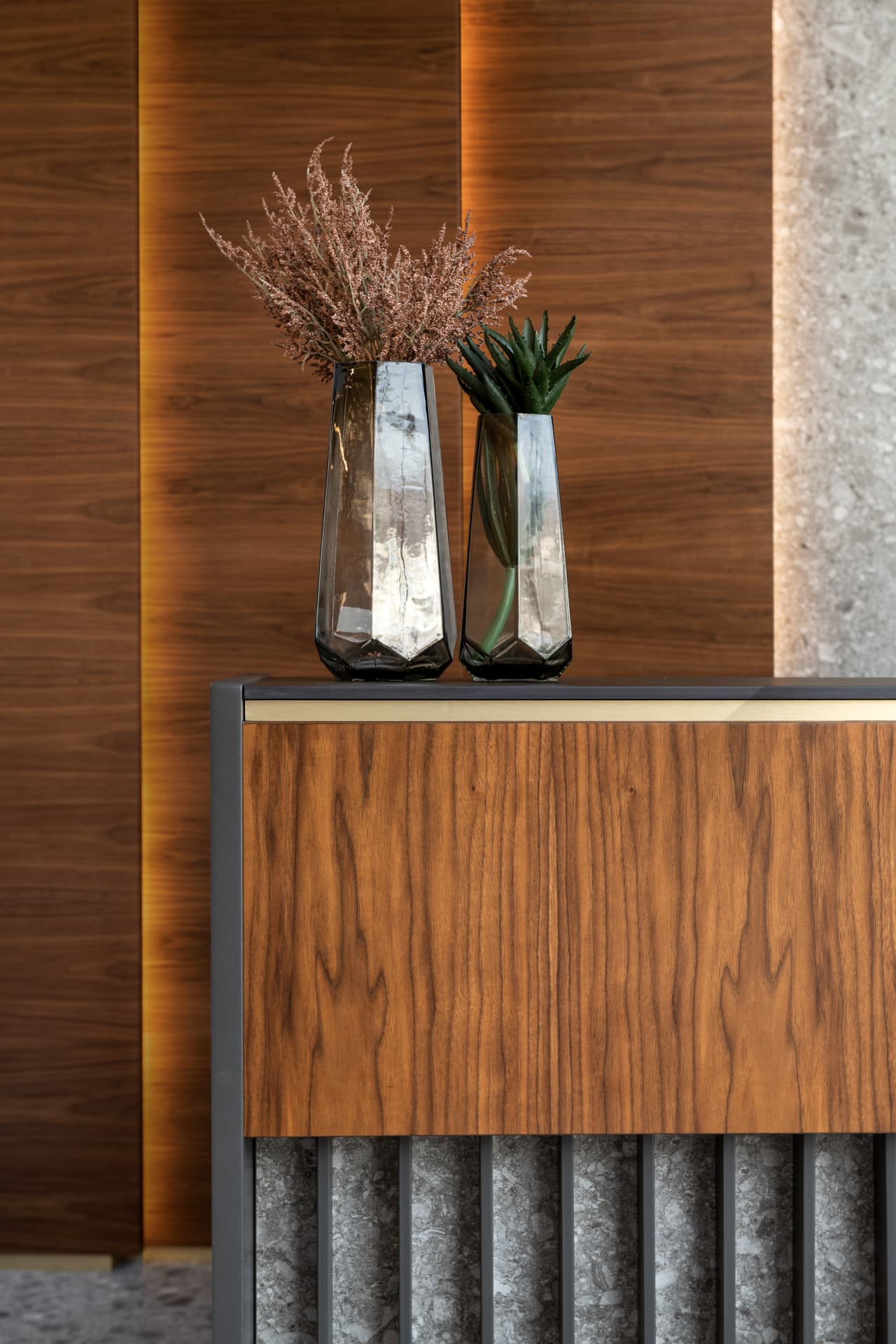 Cascading white disc pendants above fluted walnut-terrazzo desk