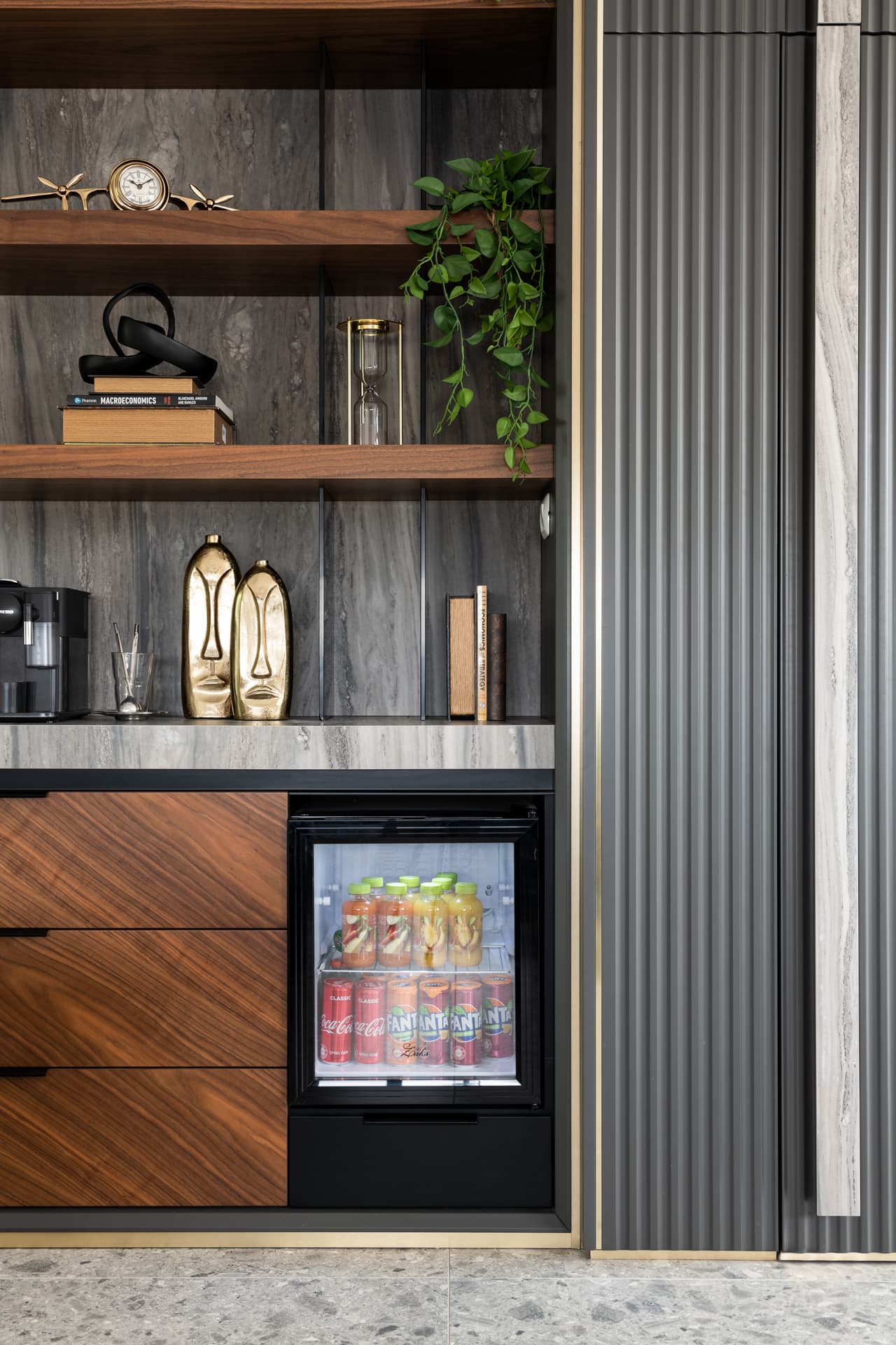 Gold geometric wall clock on walnut plinth with classical bust