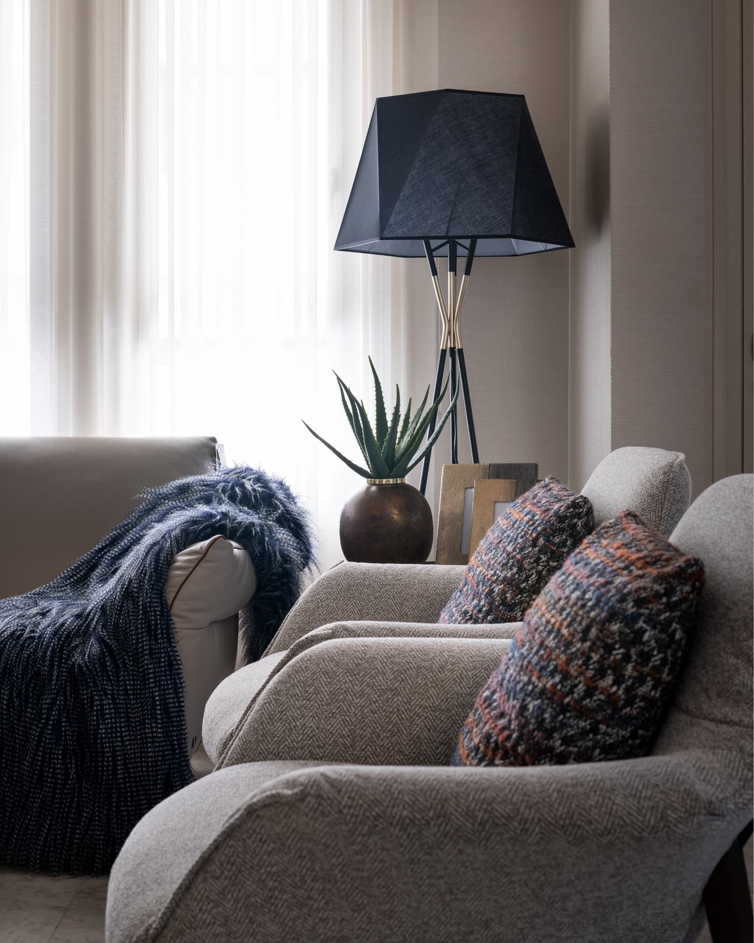Slatted red-timber pivot entrance wall with ornamental grasses
