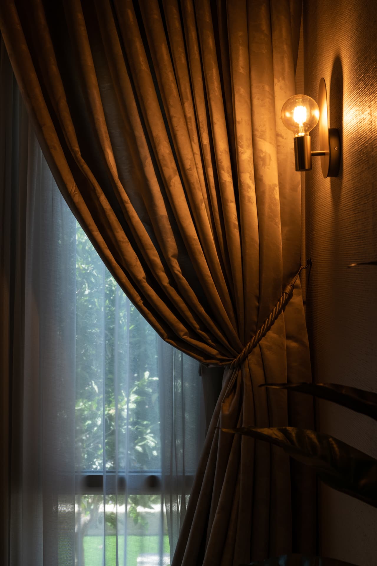 Sinuous LED pendant loop over sculptural V-base steel island