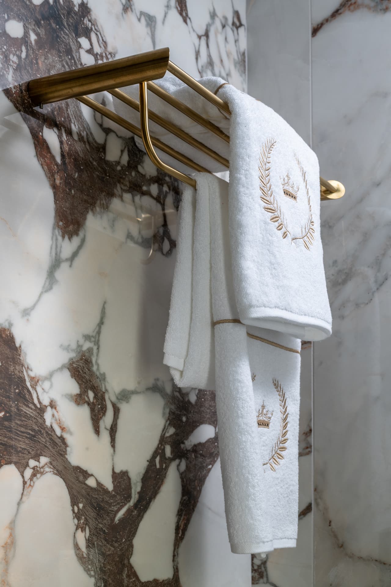 Burgundy velvet sofa with cream leather sectional and marble fireplace