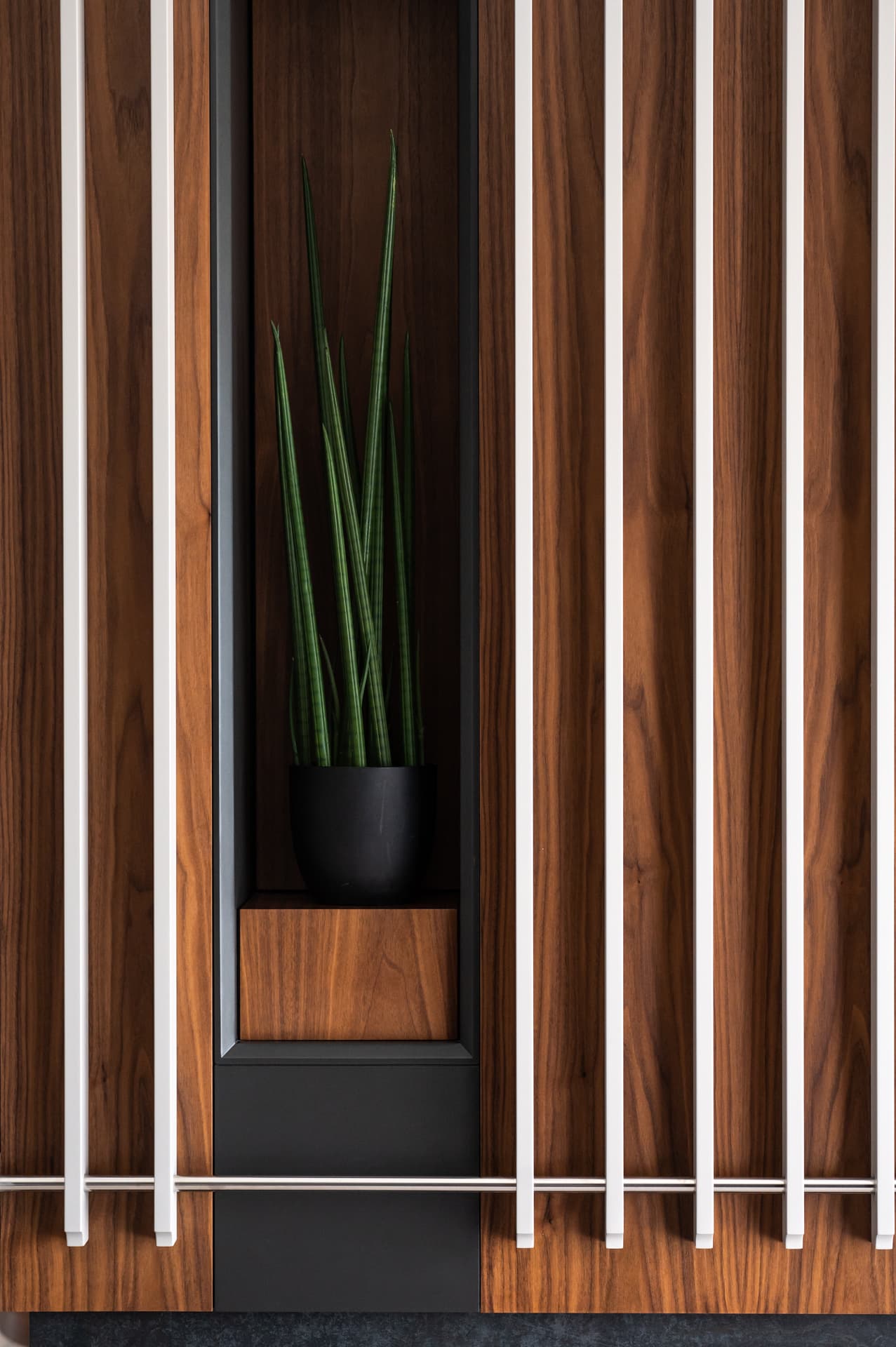 Navy velvet tufted bench at foot of grey channel headboard bed