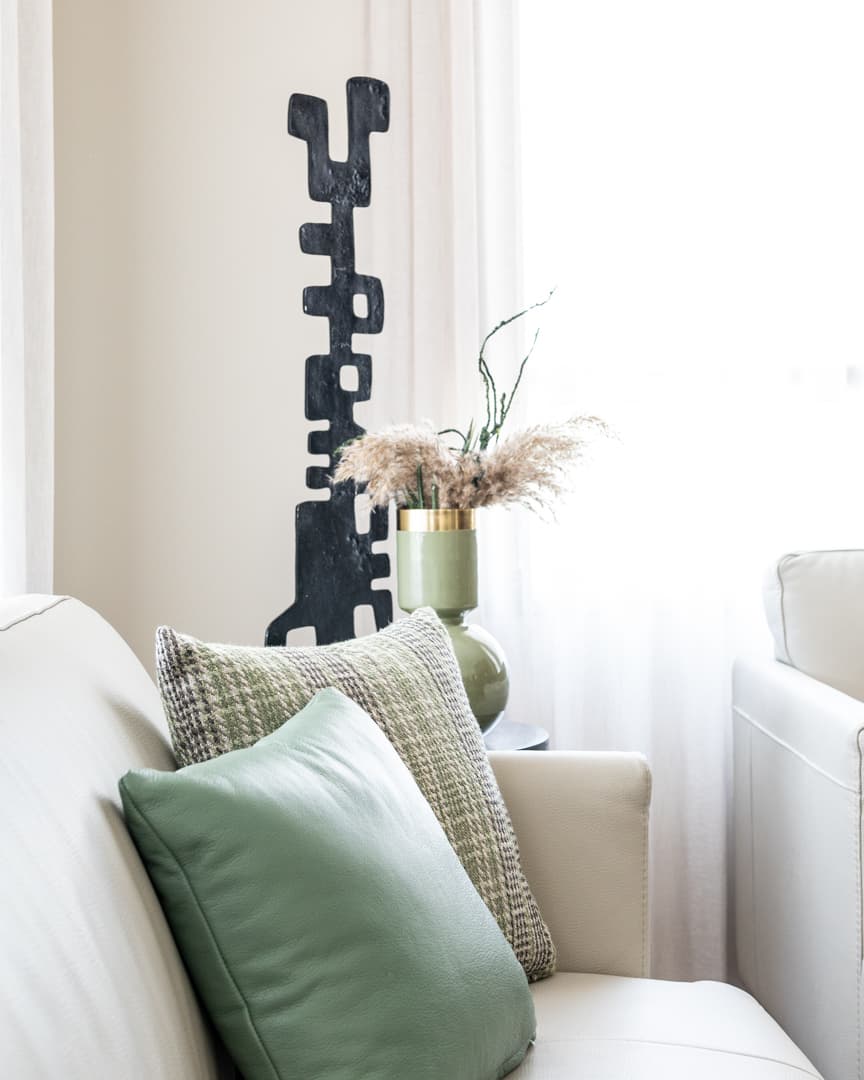 Gold mandala wall art beside walnut TV panel