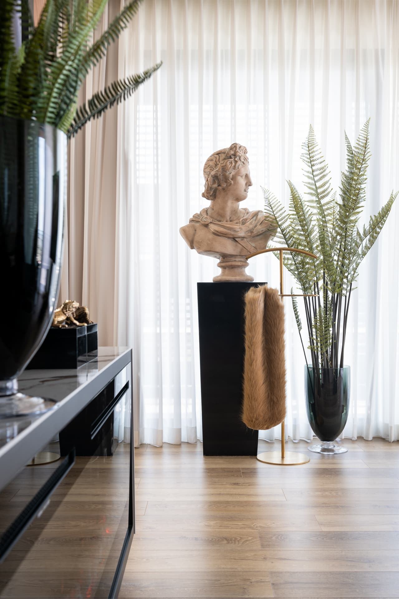 Classical sculpture photograph in greyscale facing bed