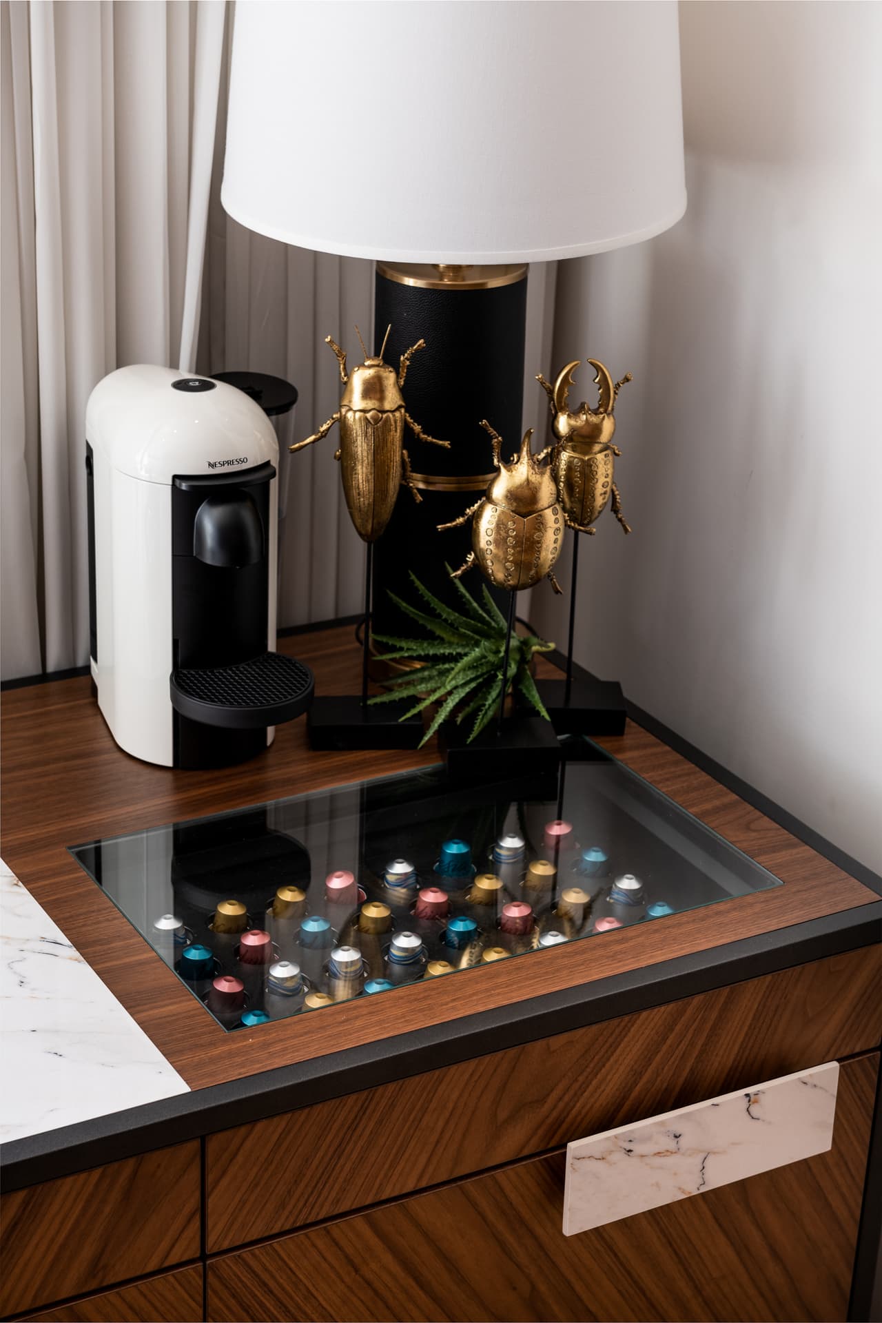 Sculptural bronze petal ceiling fan above charcoal sectional