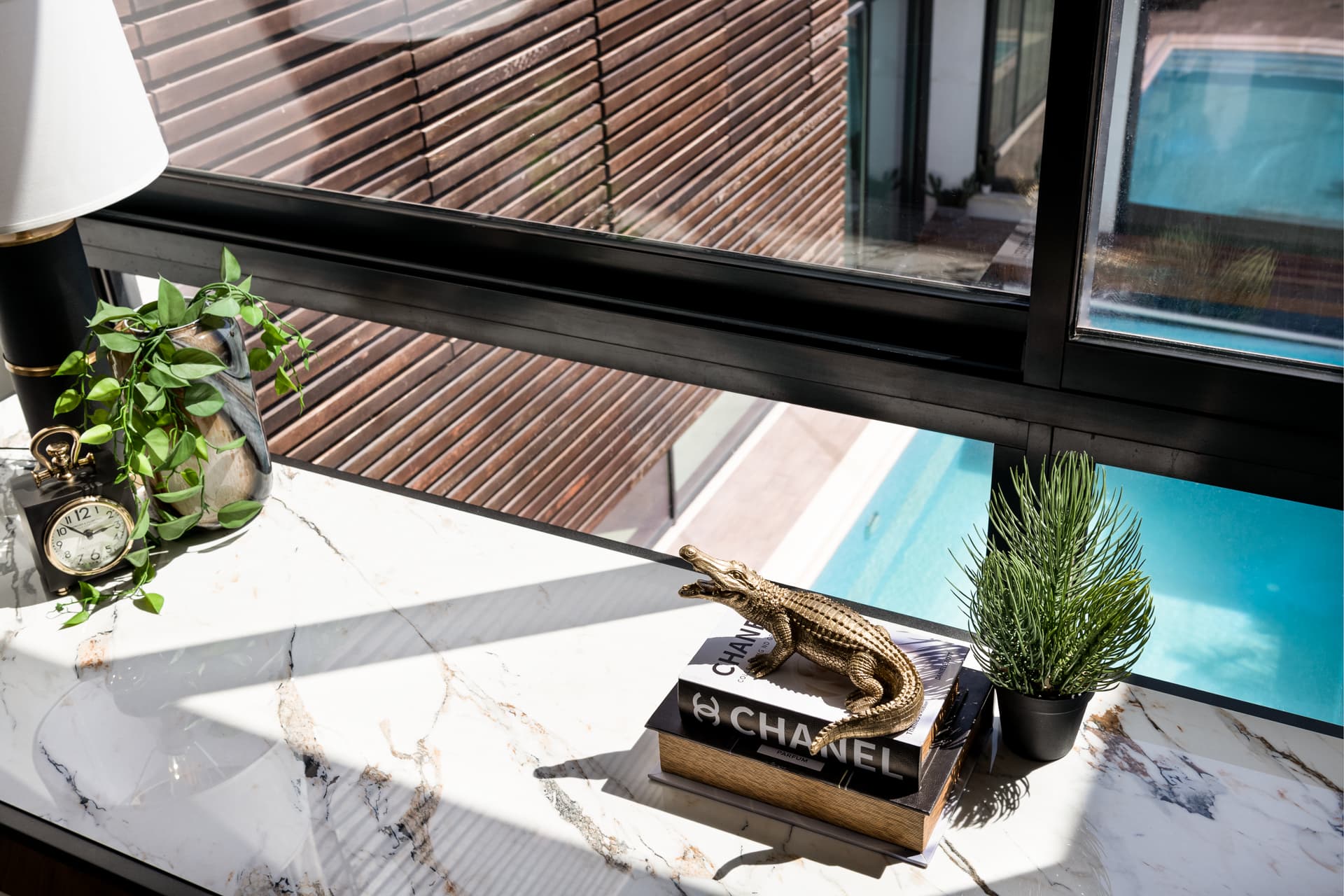 Recessed black marble appliance niche in walnut veneer wall