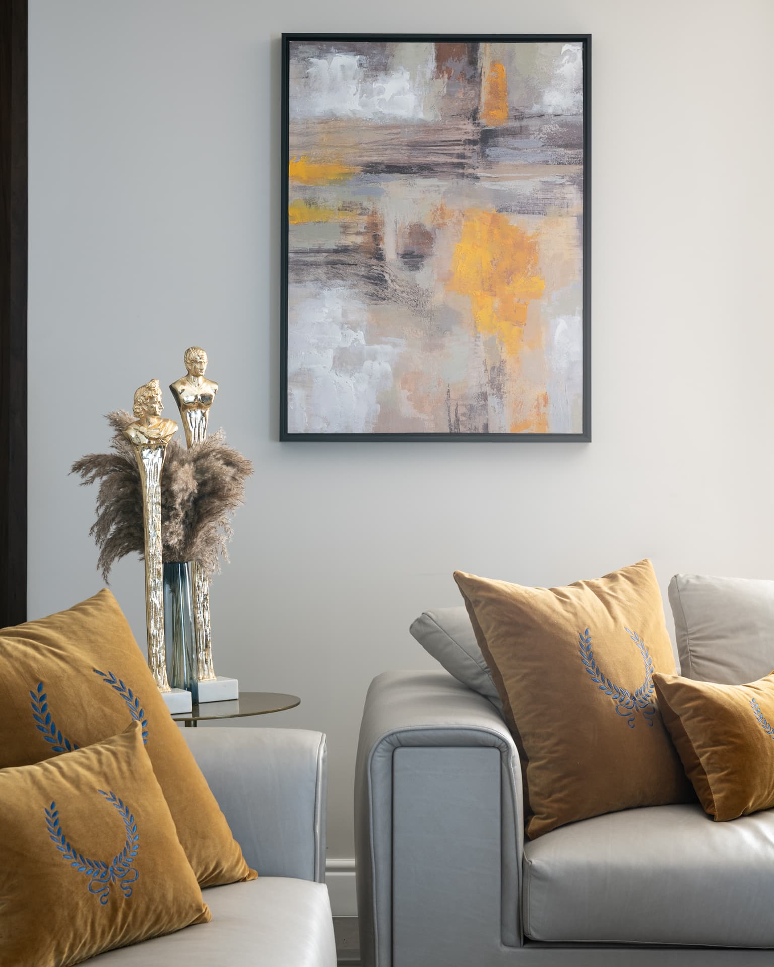 Chevron walnut vanity doors with brass picture light on cream marble