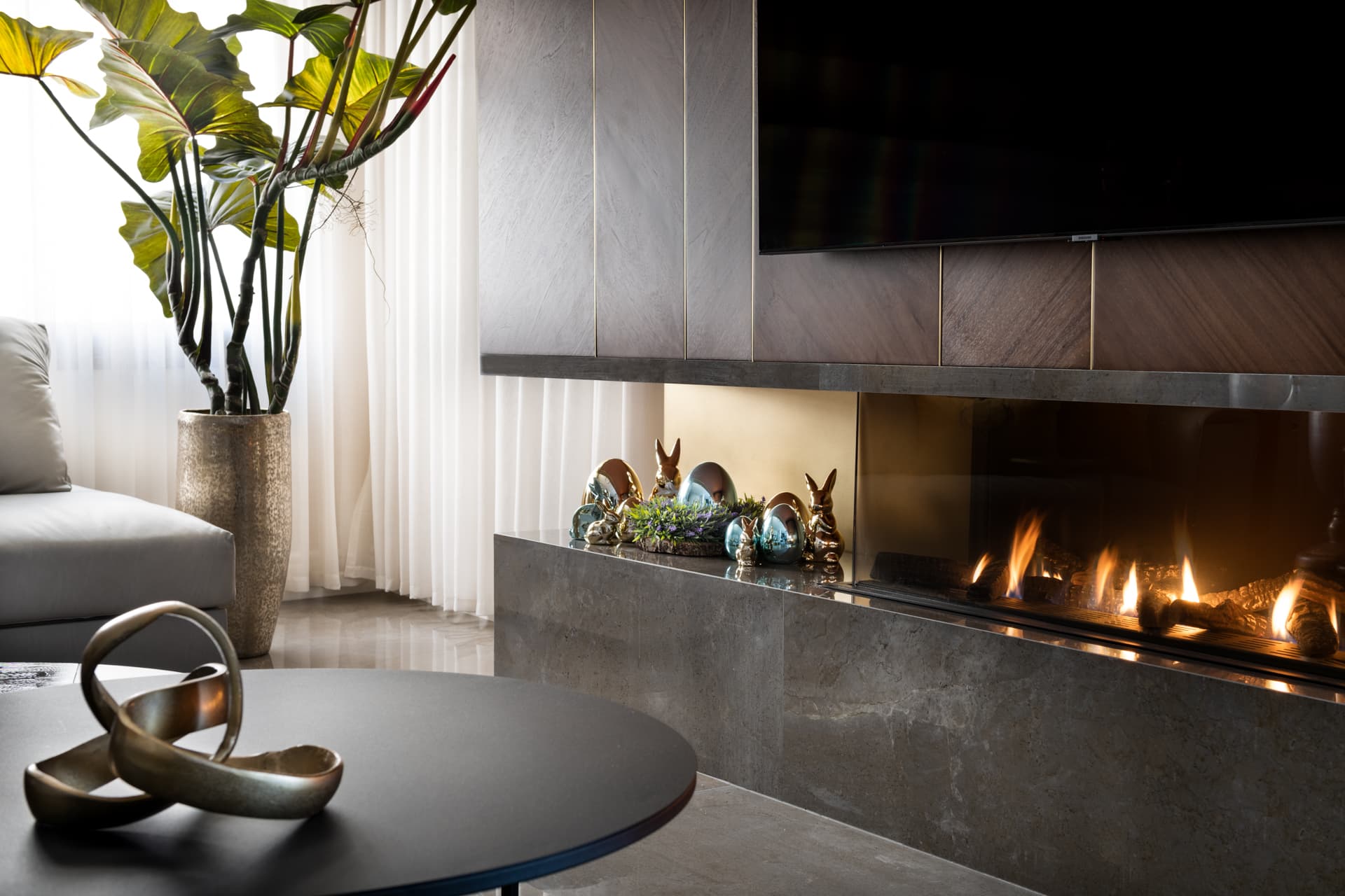 Bronze V-base console with smoked green glass vases and oval mirror